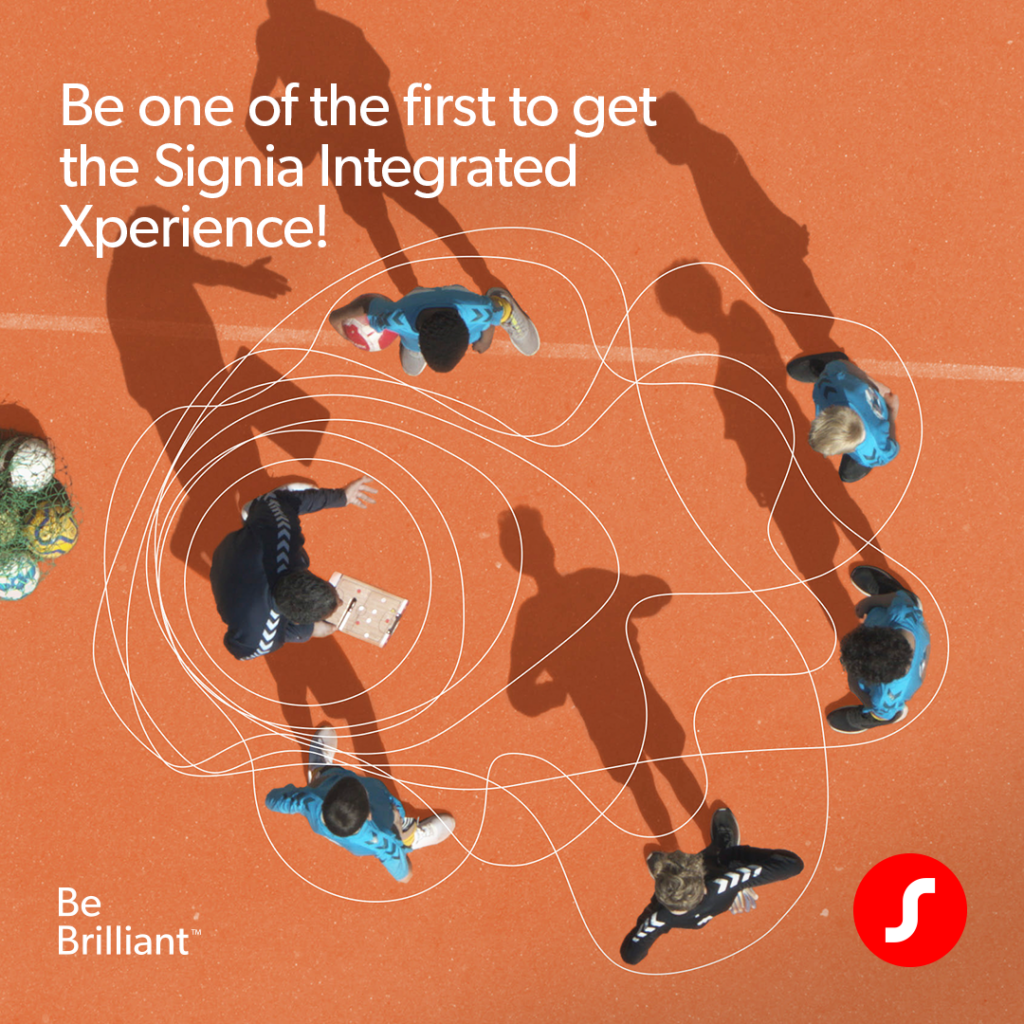 An overhead view of a youth soccer coach and several players on an orange court, overlaid with swirling white graphic soundwave lines tracking their interactions. Text reads, 'Be one of the first to get the Signia Integrated Xperience!' alongside campaign logos.