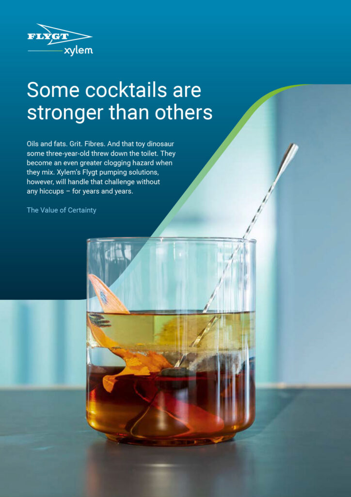 A full page ad with the Flygt and Xylem logos at the top left against a teal background. The top text reads 'Some cocktails are stronger than others' above a paragraph of body text. The bottom half shows a glass filled with layered wastewater liquids, a toy dinosaur, and a stirring spoon.